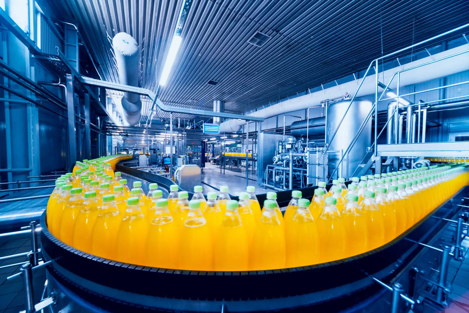 Orange drinks pass through the beverage production and filling line.
